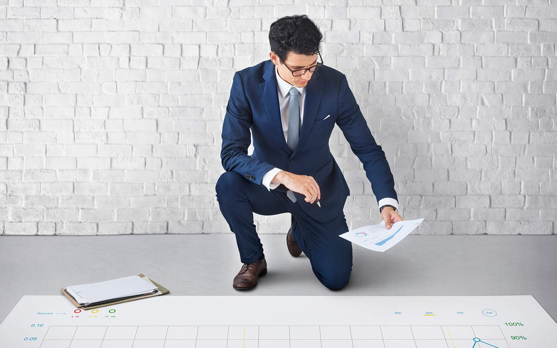 Business owner reviewing forecast graphs on laptop with accountant