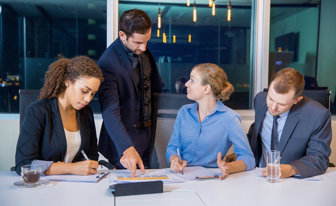 Accountant preparing year-end reports at desk with financial statements