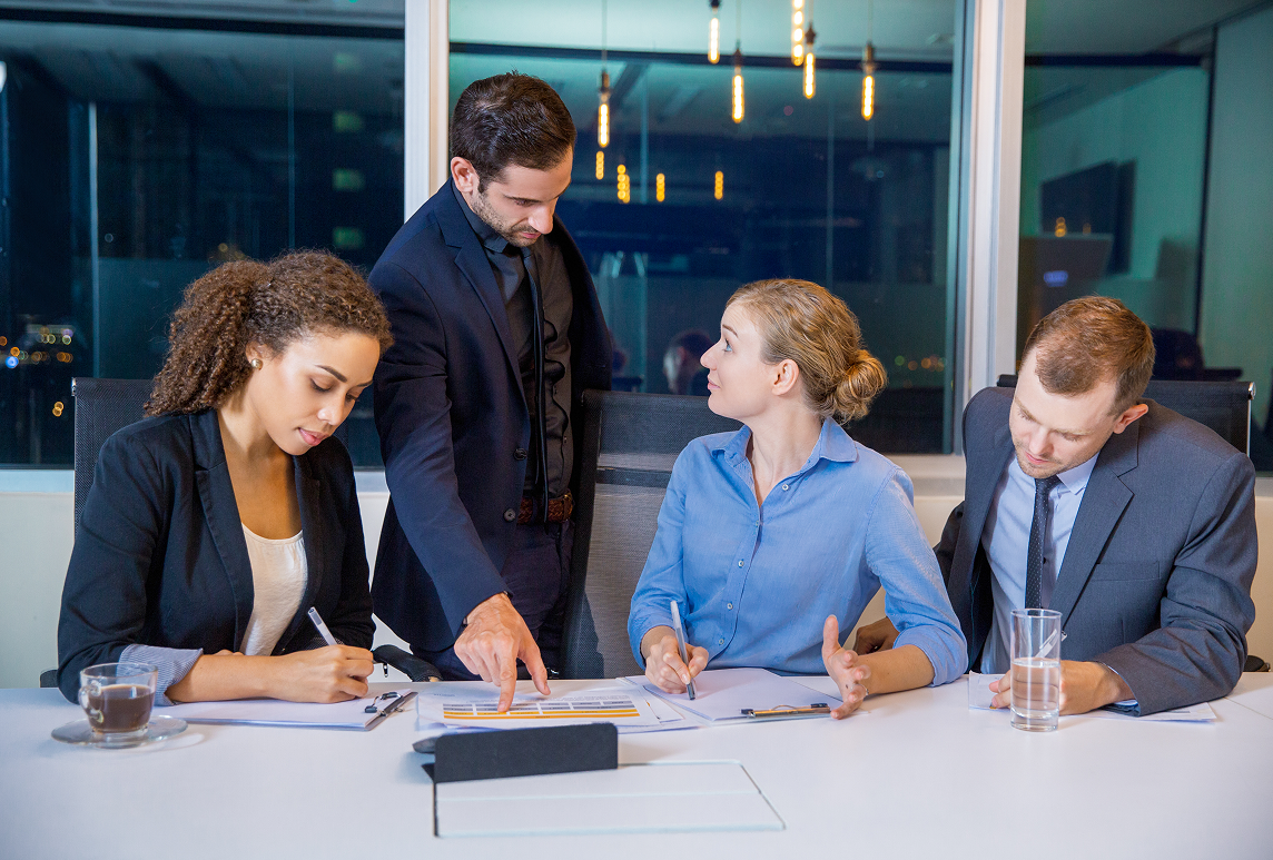 Accountant preparing year-end reports at desk with financial statements