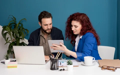 Business owner reviewing VAT registration form with accountant