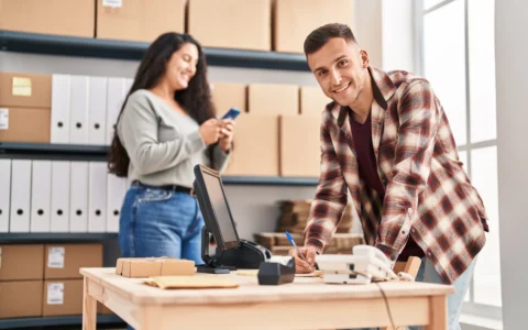 Online seller calculating VAT on ecommerce sales using laptop